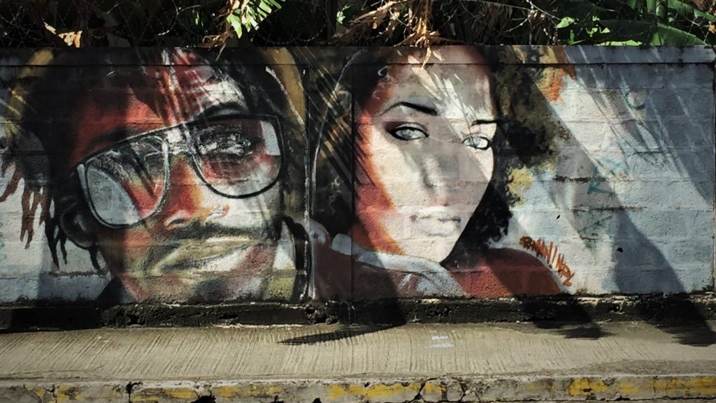 Oeuvre street art représentant un homme avec des lunettes de soleil et une femme