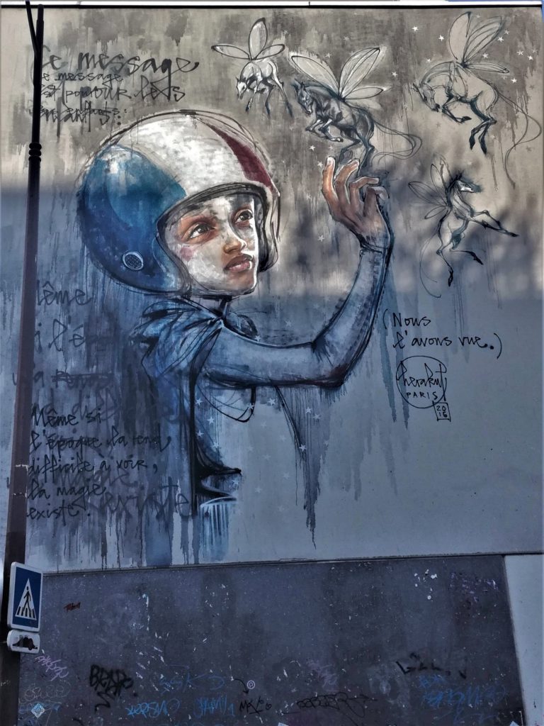 Graffiti représentant un jeune garçon avec un casque bleu blanc rouge tenant dans une main un cheval ailé